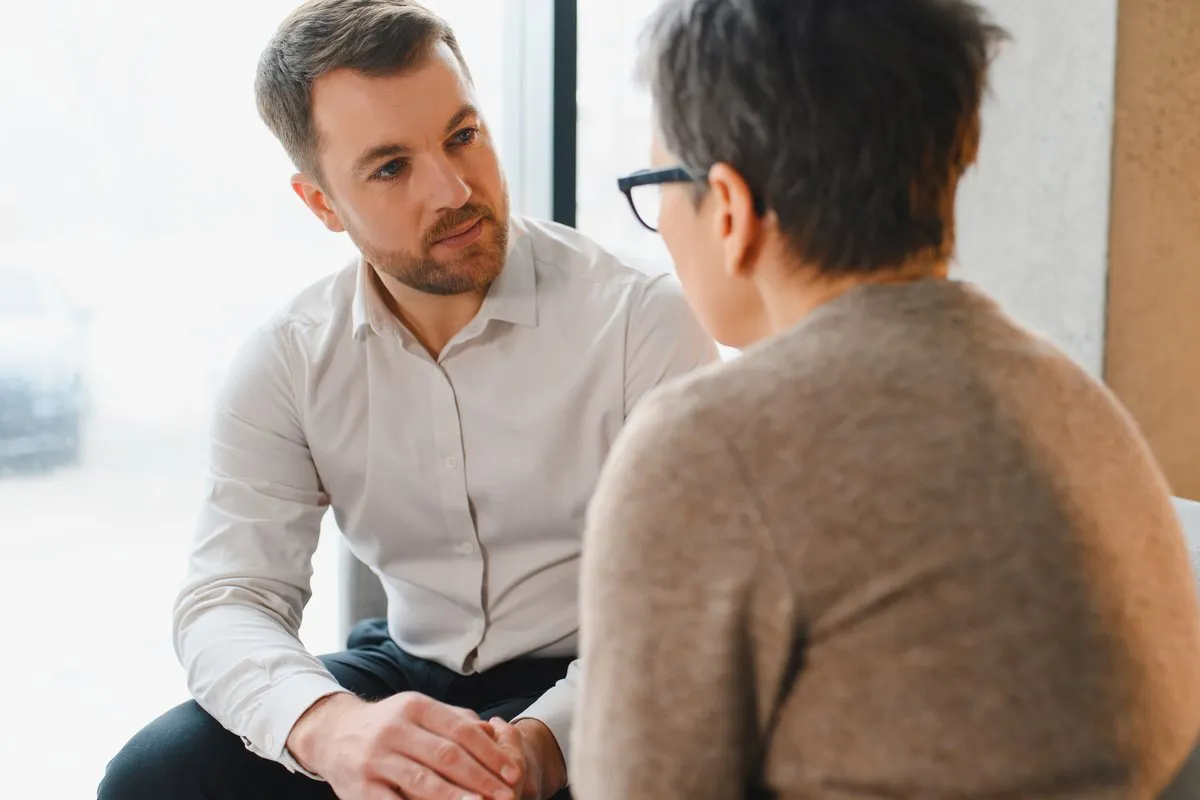 A Mental Health First Aider in conversation with a colleague